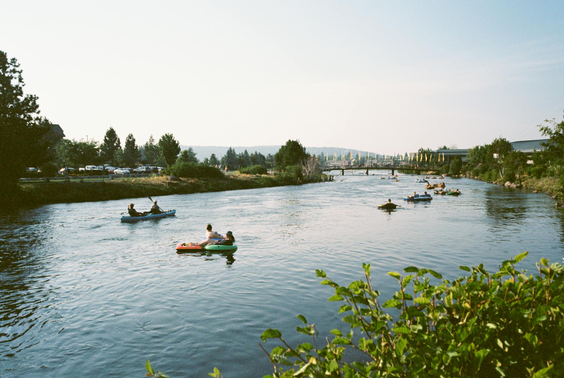 people in kayaks in a river